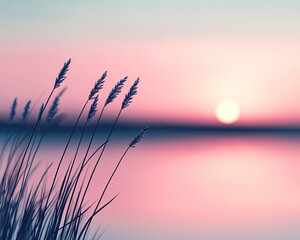 Obraz premium Serene sunset over tranquil waters, with delicate grass silhouettes framing the horizon in soft pastel hues.