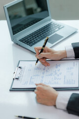 A salesperson explaining the features of a house to a client, aiming to close the sale and finalize the contract.