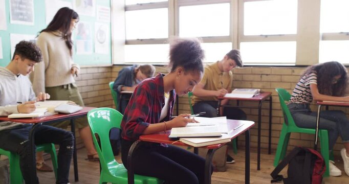 Students, girl and classroom portrait for high school, happy learning and writing notes in education or studying. Excited teenager or African kid at desk with books, language teacher and scholarship