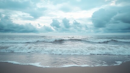Fototapeta premium Serene Beachscape with Gentle Waves under Cloudy Skies