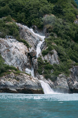 Naklejka premium Waterfall in Tracy Arm fjord south of Juneau Alaska in Tongass National Forest during summer