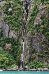 Waterfall in Tracy Arm fjord south of Juneau Alaska in Tongass National Forest during summer