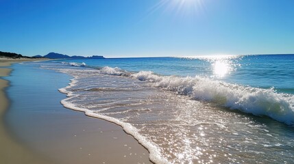 Serene Beach Landscape with Sun-Kissed Waters and Clear Blue Sky