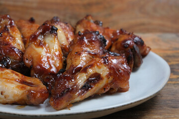 Teriyaki chicken wings on ceramic plate.