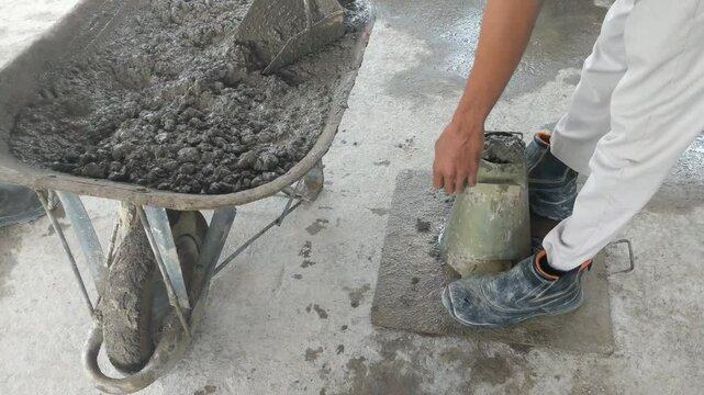 a man is performing a slump test on fresh concrete. work-ability test on concrete with the slump test method.