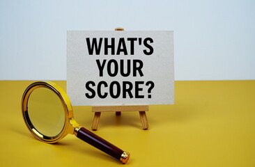 What's your score? text on paper card with magnifying glass on yellow background