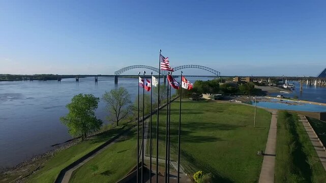 Waving Flags in Mud Island River Park, Memphis, Tennessee. Hernando de Soto Bridge and Mississippi River in Background. Drone