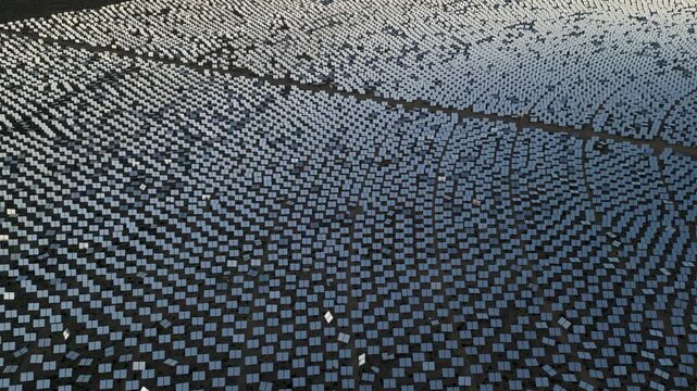 Aerial view of the ivanpah solar plant with solar panels in the mojave desert during golden hour, calada, california, united states.