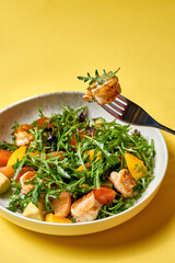 A vibrant and fresh salad featuring grilled shrimp, ripe avocado, juicy mango, and cherry tomatoes.