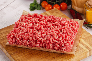 Raw minced beef meat over board