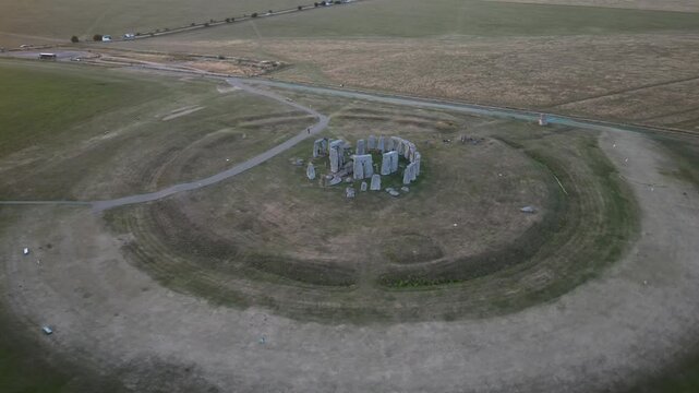 Aerial view of stonehenge at sunset surrounded by beautiful fields, amesbury, united kingdom.