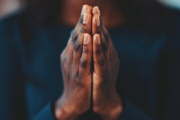 Person praying with focus on hands, serenity concept