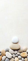 Minimalist zen stones stacked against a neutral background symbolizing balance, calm, and tranquility in a simple and soothing composition.