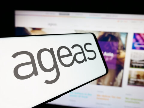 Stuttgart, Germany - 08-20-2024: Cellphone with logo of Belgian insurance company Ageas in front of business website. Focus on center-left of phone display.