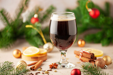 German christmas drink glühbier. Hot beer with spices -  cinnamon, anise stars, citrus and gloves. Mulled dark beer.