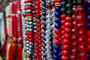 Colorful beads made of natural semiprecious stones on a white background. Isolated jewelry close...