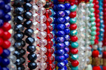Colorful beads made of natural semiprecious stones on a white background. Isolated jewelry close...