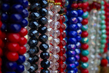 Colorful beads made of natural semiprecious stones on a white background. Isolated jewelry close...
