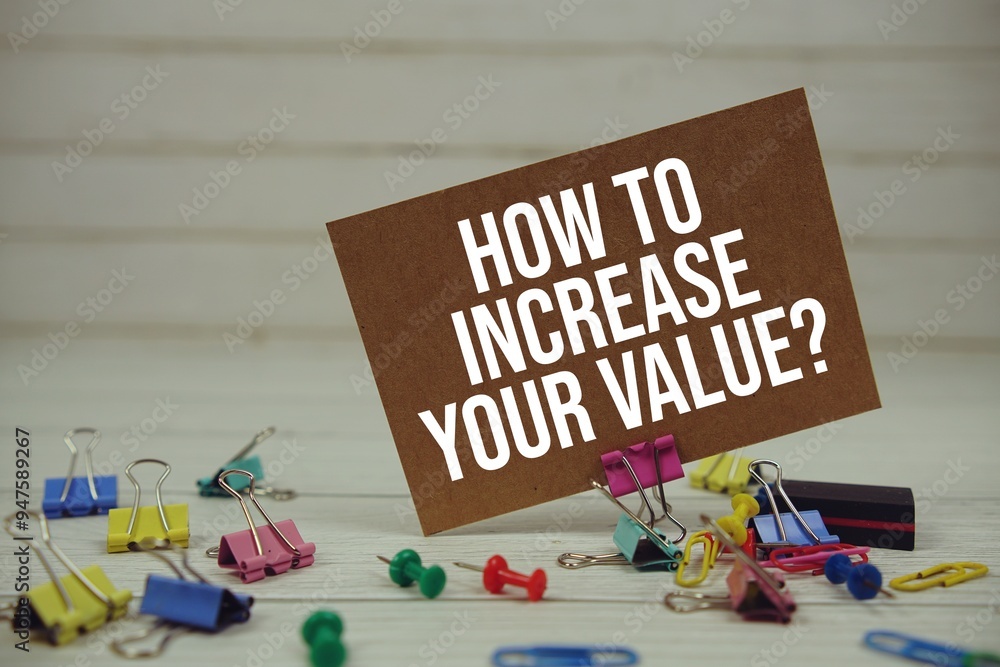 Poster how to increase your value? text on paper card with stationary on wooden background