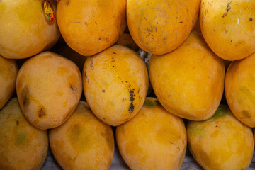 Ripe Yellow Mango with Smooth, Vibrant Skin. This high-resolution image features a perfectly ripe yellow mango, showcasing its smooth, golden skin and inviting texture