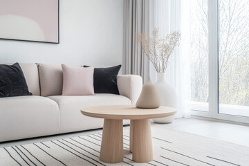 Modern interior design composition with a sofa, coffee table and minimalist decor next to a large window. Luxury interiors in neutral tones.