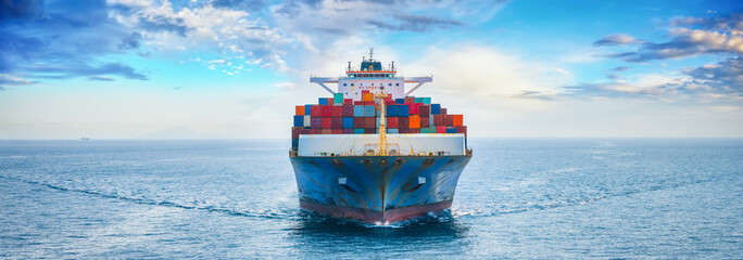 Front view of a large container cargo ship sailing over the ocean as a banner for shipping and...