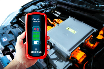 Car technician checking electric vehicle system problems with a wireless scan tool , EV electric...