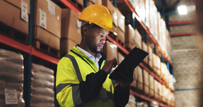 Inspection, black man or tablet in warehouse for checklist, distribution or stock management. Supply chain, employee or supervisor with tech for shipping orders, quality control or logistics at night