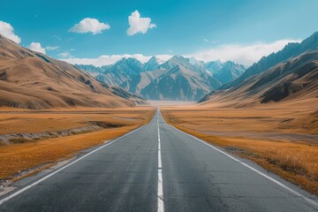 Fototapeta premium A Straight Asphalt Road Leading Through Mountain Valley