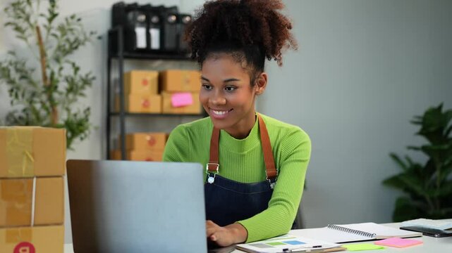 SME business owner African American female entrepreneur Checking orders and checking the number of parcels delivered online to customers who exceeded the target order. business startup ideas.