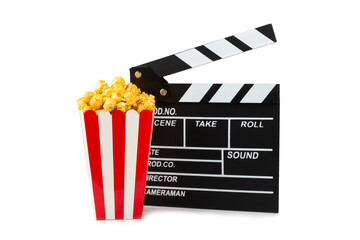 Tasty caramel popcorn in buckets and cold cola drinks with cinema tickets, movie clapper and 3D...