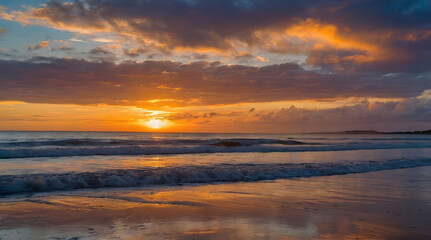 Obraz premium Sunset Over a Sandy Beach with Rolling Waves