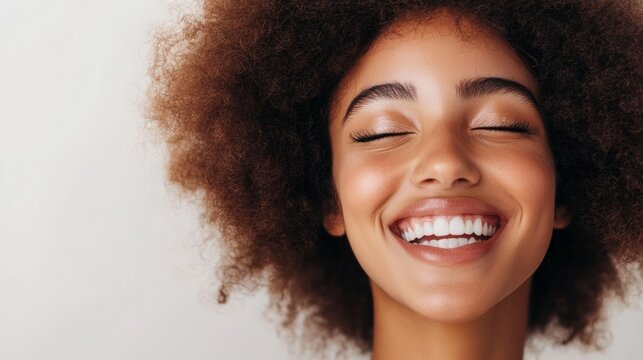 Her joyful expression lights up the room embodying health and vitality The delicate curls frame her face enhancing her natural beauty and inviting warmth