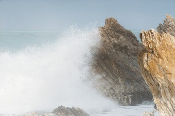 Heavy Waves Crashing on the white rock at new zealands coast