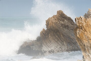 Heavy Waves Crashing on the white rock at new zealands coast