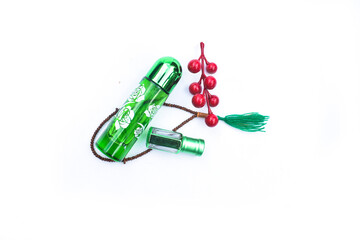 Arabic oud oil perfume in silver bottle with crystals and sticks of tree
