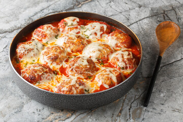 Italian casserole of baked meatballs in spicy tomato sauce with mozzarella cheese and thyme...