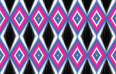 Vibrant ikat pattern seamless background. Colorful ethnic design with diamond shapes. Trendy boho chic textile print. Geometric ikat motif in blue, pink, and white. Modern ikat wallpaper. 