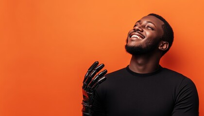 Obraz premium Joyful african american man with prosthetic hands poses against a vibrant orange background