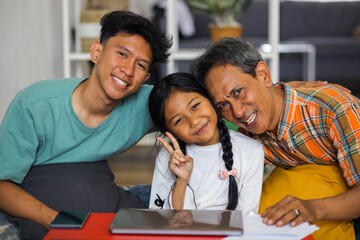 Close Up Of Happy Asian Family Smiling And Looking At Camera 