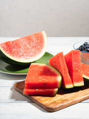 Watermelon slices on wooden cutting board, summer fruit