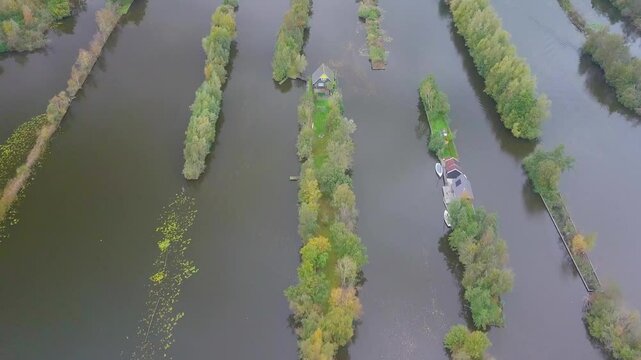 Aerial view of serene islands and tranquil water surrounded by lush greenery and boats, Breukelen, the Netherlands.
