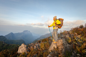 Hikers are enjoying the stunning view on the high mountains.Tourist with backpack on mountain peak.
