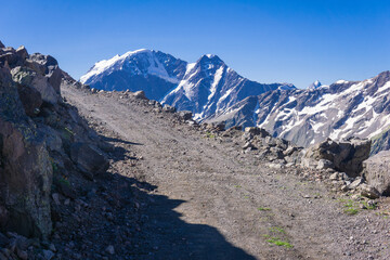 rocky dirt road through a pass in the highlands