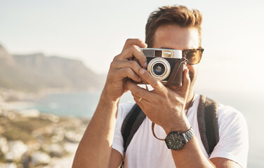 Sightseeing, portrait and man with camera for photography, document experience and capture picture of nature. Travel, photographer and memory with vintage equipment on vacation, holiday and outdoor