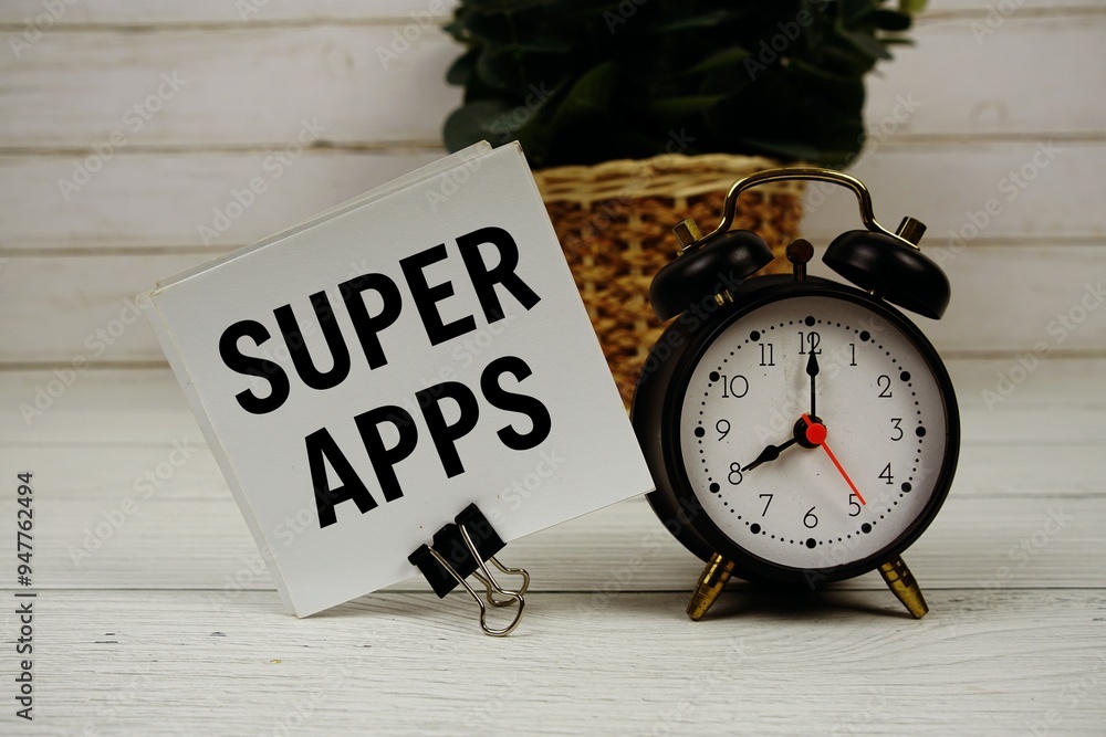 Poster super apps text message on sticky note with alarm clcok on wooden background