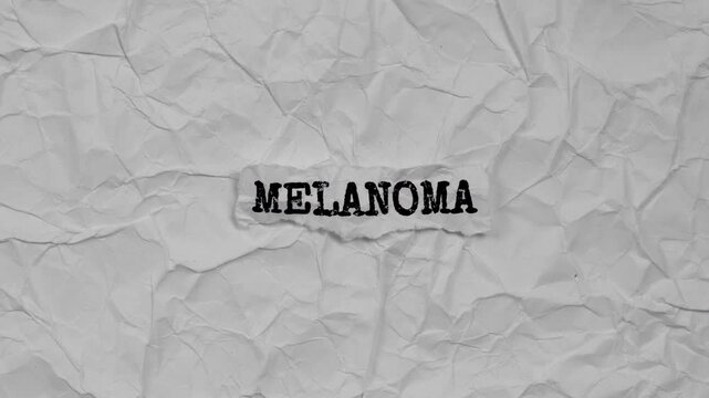 Crumpled piece of paper with word Melanoma on a crumpled paper background.
