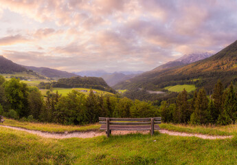Meadow with road and bench during sunset in Berchtesgaden National Park