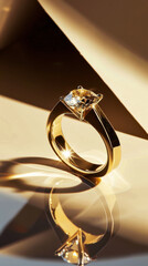 A gold ring with a diamond in the center. The ring is sitting on a table and the reflection of the ring can be seen in the table.