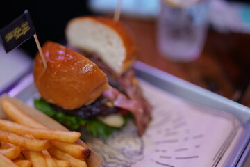 Bacon beef burger combo, french fries, on wooden table